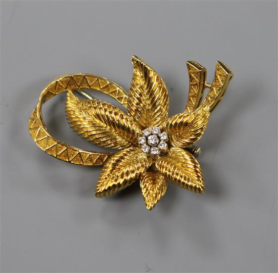 An 18ct gold and diamond set flower brooch, gross 16.8 grams.